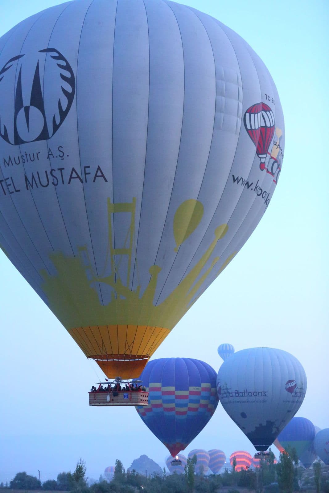Passengers at the rail of a hot air balloon basket over Cappadocia