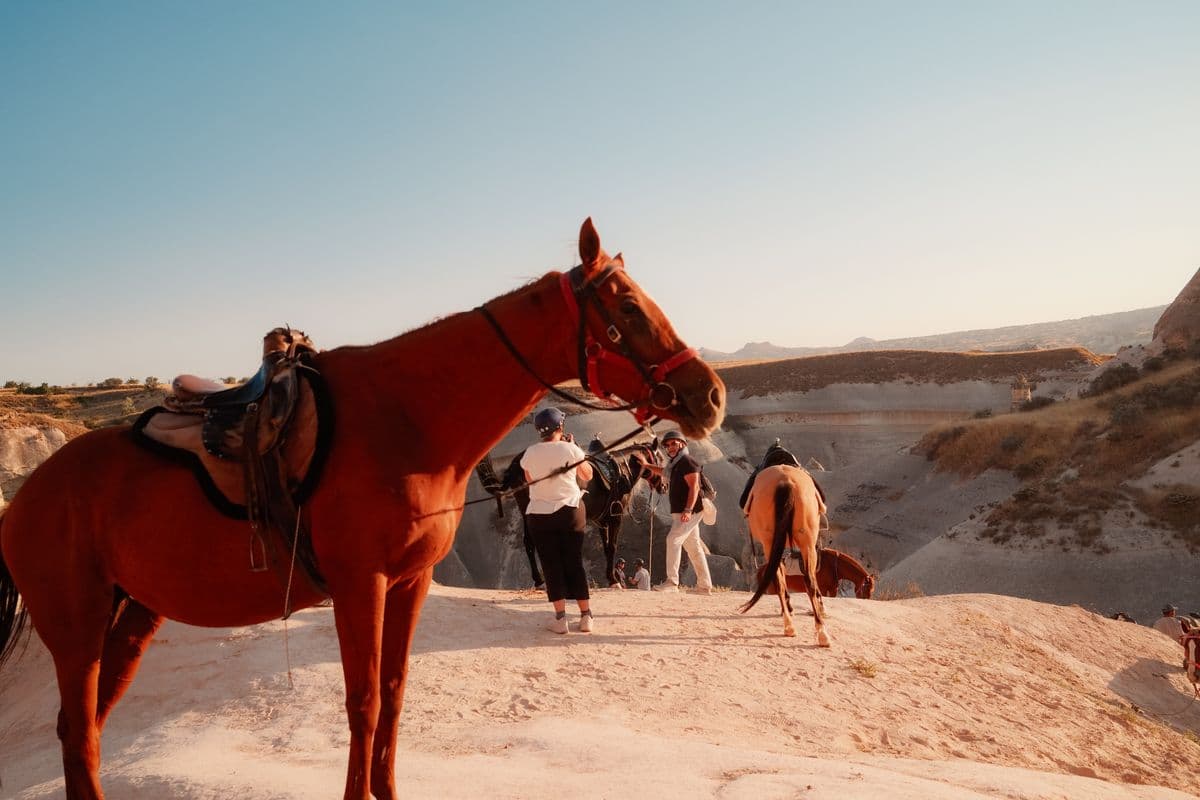 Riders on horseback among the fairy chimneys near Göreme, Cappadocia