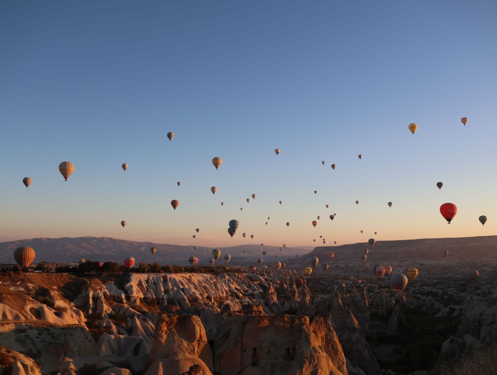 Hot air balloons rising over Göreme at sunrise